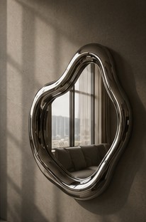 Close-up detail of a BLOWNMIRROR chrome edge catching window light